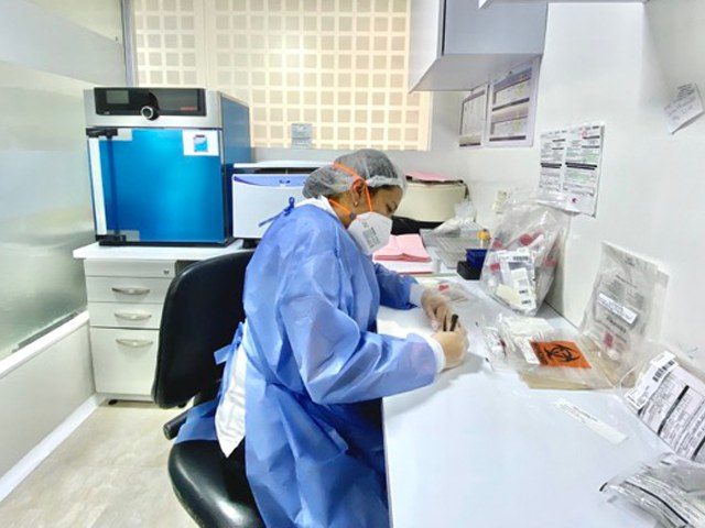Profesional de Uniendo procesando muestras en el laboratorio del centro